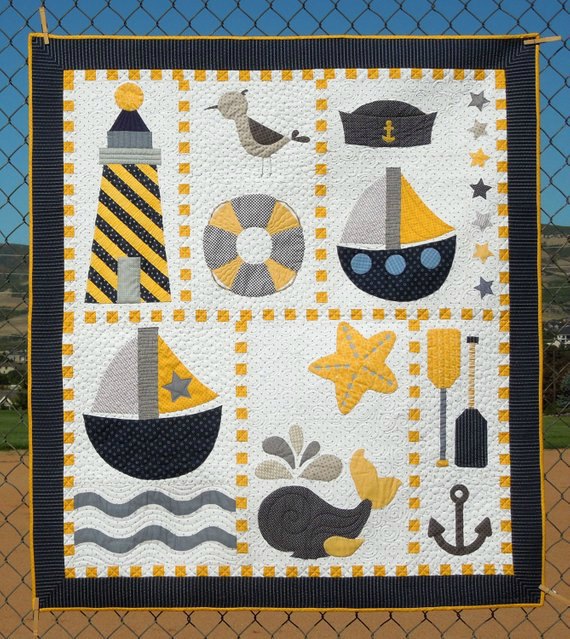 How beautiful would this nautical quilt look in a nursery or young boys bedroom? You can download the pattern and tutorial for the Ahoy Quilt Pattern below. This Nautical Quilt is absolutely full of fun and cute nautical items like a lighthouse, sailor's cap, ship's, a whale spouting water, a starfish, some oars and an anchor.